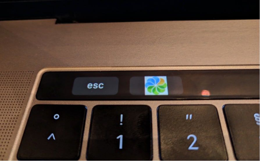 The MacBook Pro Touch Bar with Alfresco logo Alfresco Devcon 2019